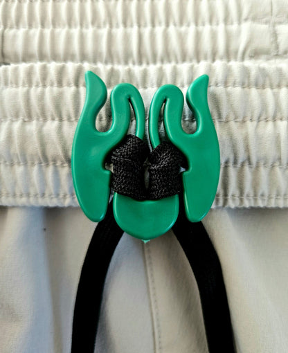 Close up picture demonstration  of Wiggley, a tool that keeps clothing drawstrings from getting lost in the washer.