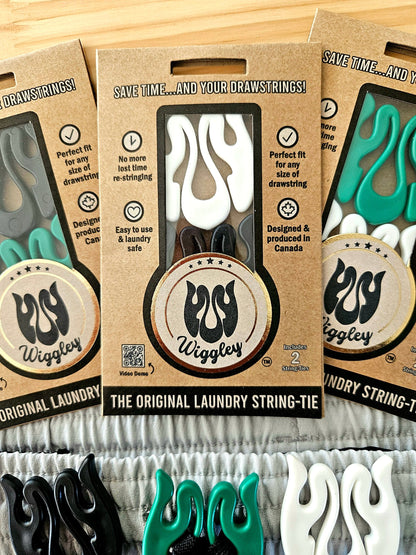 Photo of Wiggley String-Tie eco-friendly packaging, showcasing its unique shape and purpse, to secure drawstrings on clothing items in the wash and dry cycle of laundry.